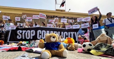 Italian and European parliament members hold placards during a protest in front of the Egyptian side of the Rafah border crossing, calling for an end to the war and for aid to be allowed into the Gaza Strip, May 18, 2025. (AFP Photo)