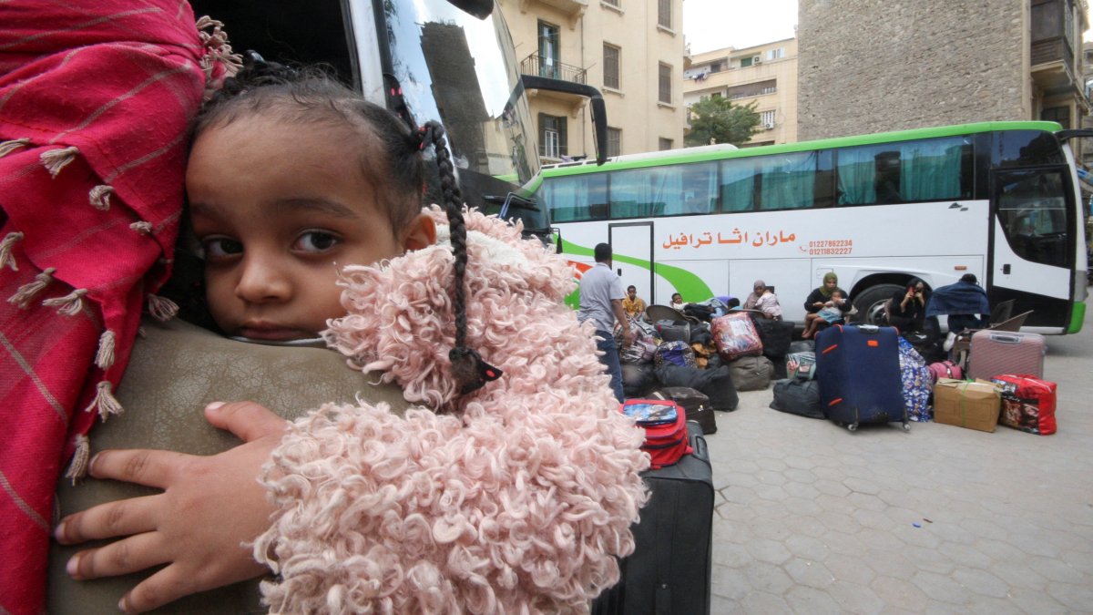 A Sudanese refugee girl looks on as other refugee families wait next their luggage at an assembly point for buses, arranged for their voluntary return from Egypt to Sudan following the Sudanese army&amp;#039;s recapture of major swathes of the capital region of Khartoum from its foe, the paramilitary Rapid Support Forces (RSF), in Cairo, Egypt, April 11, 2025. (Reuters Photo)