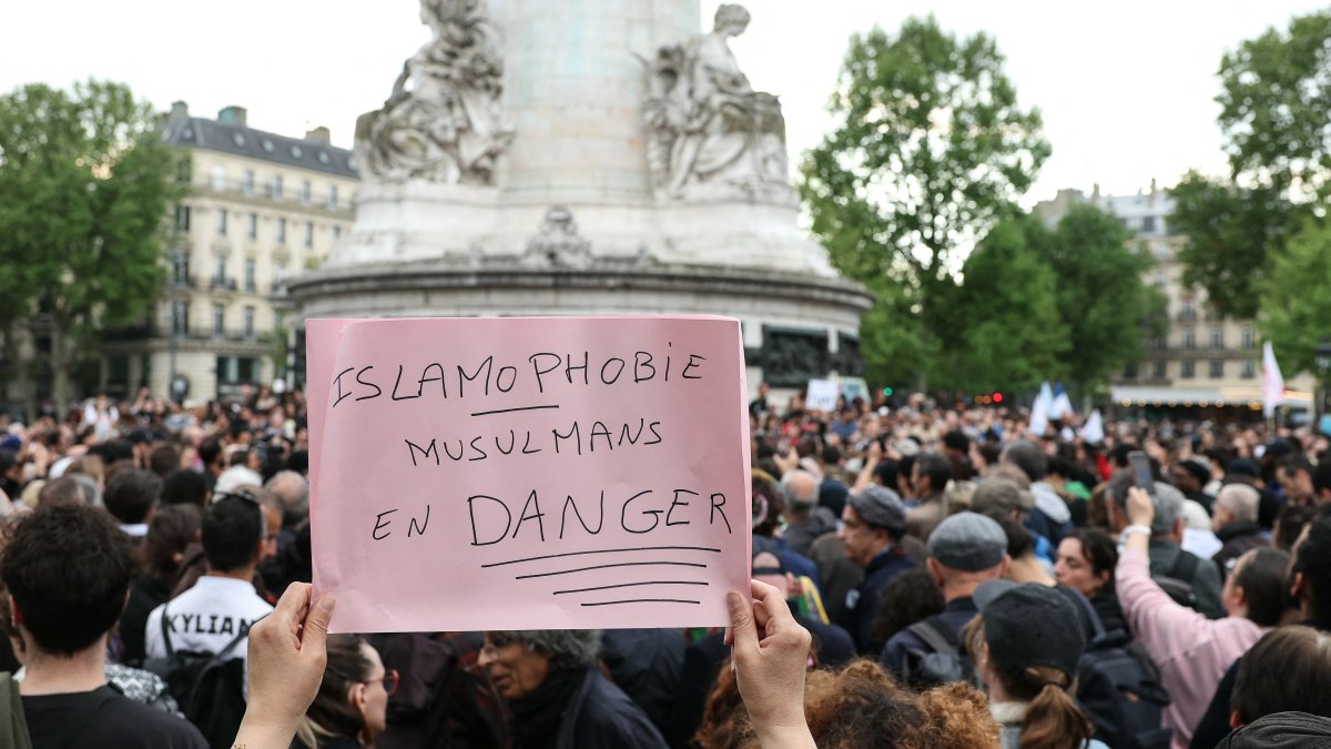 A protestor holds a sign reading &quot;Islamophobia, Muslims in danger&quot; during a gathering in tribute to Aboubakar, the worshipper killed in a mosque at La Grand-Combe, and against Islamophobia, at the Place de la Republique in Paris on April 27, 2025. (AFP Photo)