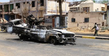 A Sudanese man walks past destroyed military vehicles in front of a hospital in Khartoum, Sudan, April 28, 2025. (AFP Photo)