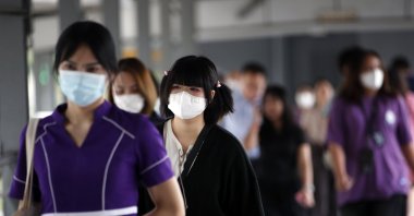 People wearing face masks walk in a public area in Bangkok, Thailand, May 20, 2025. (EPA Photo)