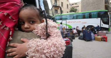 A Sudanese refugee girl looks on as other refugee families wait next their luggage at an assembly point for buses, arranged for their voluntary return from Egypt to Sudan following the Sudanese army&amp;#039;s recapture of major swathes of the capital region of Khartoum from its foe, the paramilitary Rapid Support Forces (RSF), in Cairo, Egypt, April 11, 2025. (Reuters Photo)
