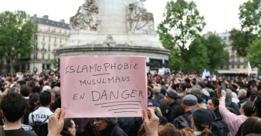A protestor holds a sign reading &quot;Islamophobia, Muslims in danger&quot; during a gathering in tribute to Aboubakar, the worshipper killed in a mosque at La Grand-Combe, and against Islamophobia, at the Place de la Republique in Paris on April 27, 2025. (AFP Photo)
