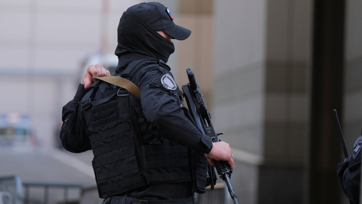 A Russian law enforcement officer secures the area near the accident scene following a reported Ukrainian drone shot down in Moscow, Russia, Aug.18, 2023. (Reuters File Photo)