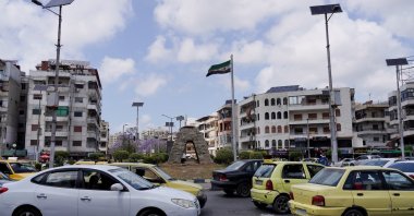A Syrian flag flutters near a street, on the day U.S. President Donald Trump announces that he would order the lifting of sanctions on Syria, Latakia, Syria, May 14, 2025. (Reuters Photo)