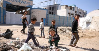 Children play around waste in front of the closed U.N. agency for Palestinian refugees (UNRWA) headquarters in Gaza City, Palestine, May 20, 2025. (AFP Photo)