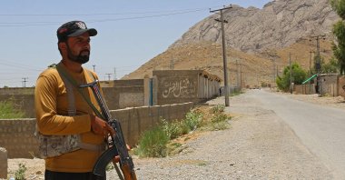 A security personnel stands guard along a street near the site of a school bus bombing in the Khuzdar district of Balochistan province, southwestern Pakistan, May 21, 2025. (AFP Photo)