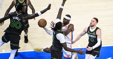 Oklahoma City Thunder guard Shai Gilgeous-Alexander (2nd R), shoots against Minnesota Timberwolves forward Julius Randle (L) and Minnesota Timberwolves center Naz Reid (C), during the second half of the Western Conference finals playoff game 1 at Paycom Center, Oklahoma City, U.S., May 20, 2025. (EPA Photo)