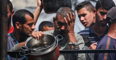 Palestinians react after the food ran out at a charity kitchen they queue at for a hot meal in Jabalia in the northern Gaza Strip, Palestine, May 17, 2025. (AFP Photo)