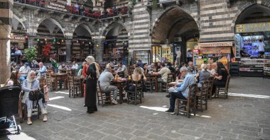 People sit in a traditional Turkish tea house near the Great Mosque of Diyarbakır (Ulu Camii) in the historical Sur district after the announcement of the PKK&#039;s dissolution, Diyarbakır, southeastern Türkiye, May 12, 2025. (AFP Photo)