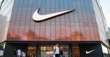 People walk past a Nike store, Beijing, China, May 14, 2025. (EPA Photo)