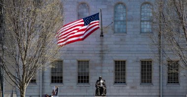 Demonstrators with signs stand around the John Harvard Statue in Harvard Yard following a rally against President Donald Trump’s attacks on Harvard University at Harvard University in Cambridge, Massachusetts, April 17, 2025. (AFP Photo)