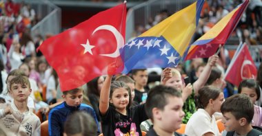 A child holds the flags of Türkiye and Bosnia-Herzegovina during the “My Choice is Turkish” Children’s Festival, Zenica, Bosnia-Herzegovina, May 22, 2025. (AA Photo)