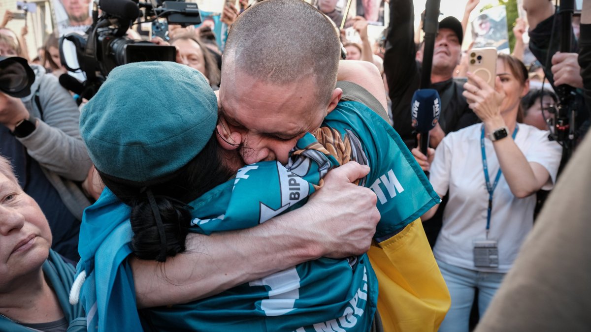 A Ukrainian soldier recently released from Russian captivity is reunited with his family on his arrival in Chernigiv Oblast, Ukraine, May 23, 2025. (EPA Photo)