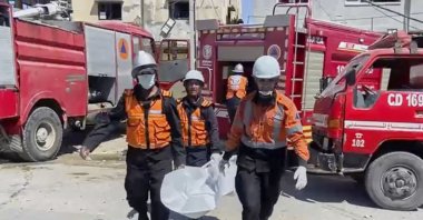 In this frame grab from a video released by Gaza Civil Defense, workers collect human remains after an Israeli strike on a home in Khan Younis killed nine of a doctor&#039;s ten children while she was at work, according to Ahmad al-Farra, head of the pediatric department at Nasser Hospital, Khan Younis, Gaza Strip, May 24, 2025. (AP Photo)
