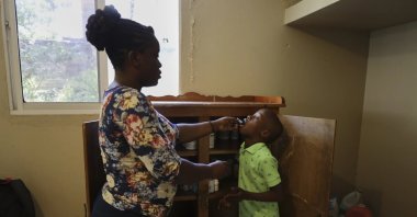 Nurse Prejuste Mexandra administers medicine to a child at the Caring for Haitian Orphans with AIDS orphanage, in Balan, Plaine-du-Nord, Haiti, May 21, 2025. (AP Photo)
