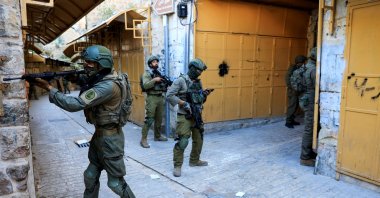 Israeli troops stand guard during a weekly settlers&#039; tour in Hebron, West Bank, Palestine, May 24, 2025. (Reuters Photo)