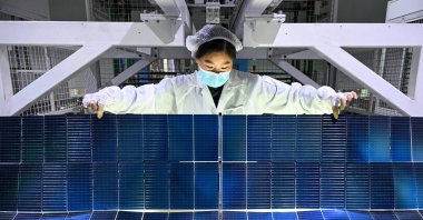 A worker produces photovoltaic modules for solar panels in a factory, Suqian, Jiangsu province, China, Jan. 23, 2025. (AFP Photo)