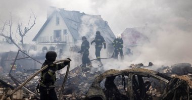 Emergency workers extinguish fire in the debris of a private house that was destroyed in a Russian rocket strike, in Markhalivka, Kyiv region, Ukraine, May 25, 2025. (Reuters Photo)