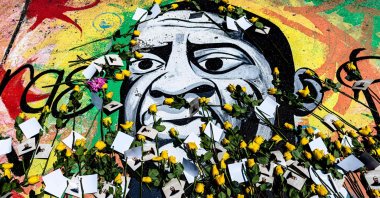 A mural of George Floyd is adorned with yellow roses and paper notes at George Floyd Square, in Minneapolis, Minnesota, U.S., May 23, 2025. (AFP Photo)
