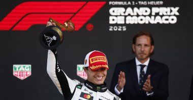 McLaren&#039;s Lando Norris celebrates on the podium with a trophy after winning the Monaco Grand Prix at the Circuit de Monaco, Monaco, May 25, 2025. (Reuters Photo)
