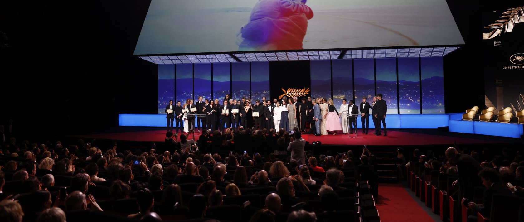 Iranian director Jafar Panahi (C) celebrates with other awardees and jury members on stage after winning the Palme d&#039;Or during the 78th annual Cannes Film Festival, Cannes, France, May 24,  2025. (EPA Photo)