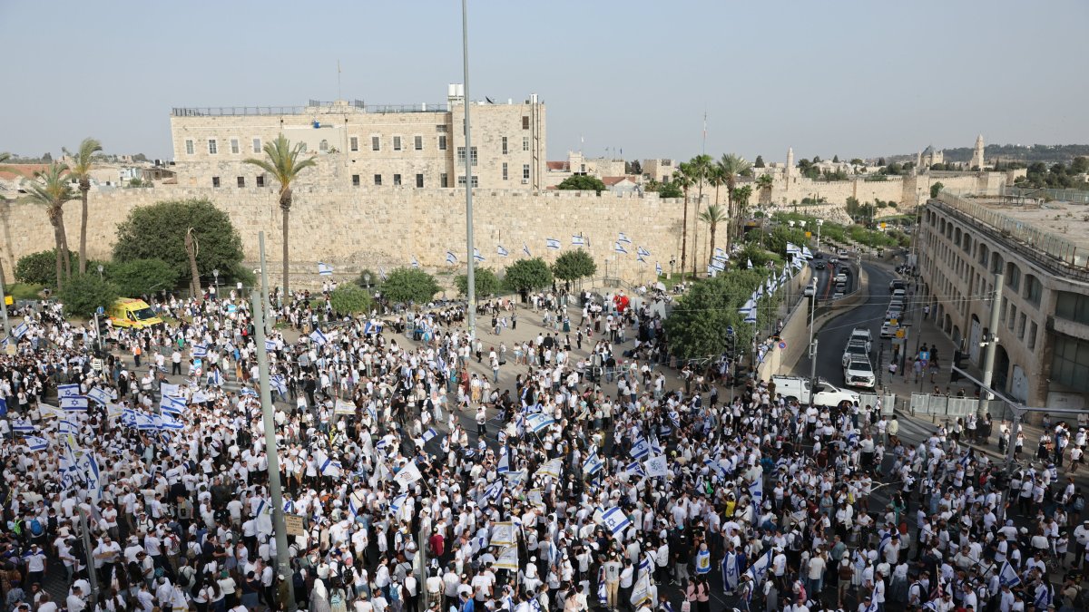 Israeli youths dancing with flags to celebrate the occupation of East Jerusalem, near the Old City of Jerusalem, May 26, 2025. (EPA Photo)
