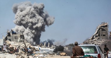 People watch as smoke billows following an Israeli strike in Jabalia, Gaza Strip, Palestine, May 25, 2025. (AFP Photo) 
