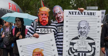 People wear masks depicting U.S. President Donald Trump and Israeli Prime Minister Benjamin Netanyahu during a demonstration in solidarity with Palestinians calling for a halt in arms trade and relations with Israel, Madrid, Spain, May 10, 2025. (Reuters Photo)