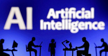 Figurines with computers and smartphones are seen in front of the words &quot;Artificial Intelligence AI&quot; in this illustration made Feb. 19, 2024. (Reuters Photo)