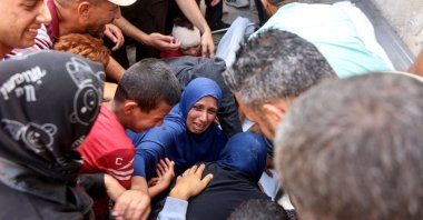People mourn over the shrouded bodies of relatives killed in an Israeli strike, at al-Shifa hospital in Gaza City, Palestine, May 26, 2025. (AFP Photo)