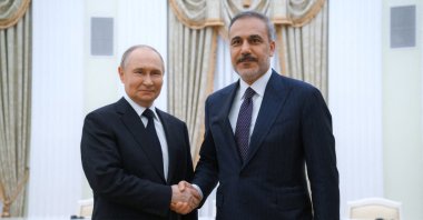 Russian President Vladimir Putin and Foreign Minister Hakan Fidan shake hands as they pose for photos before a meeting at the Kremlin in Moscow, Russia, May 26, 2025. (Sputnik via Reuters)