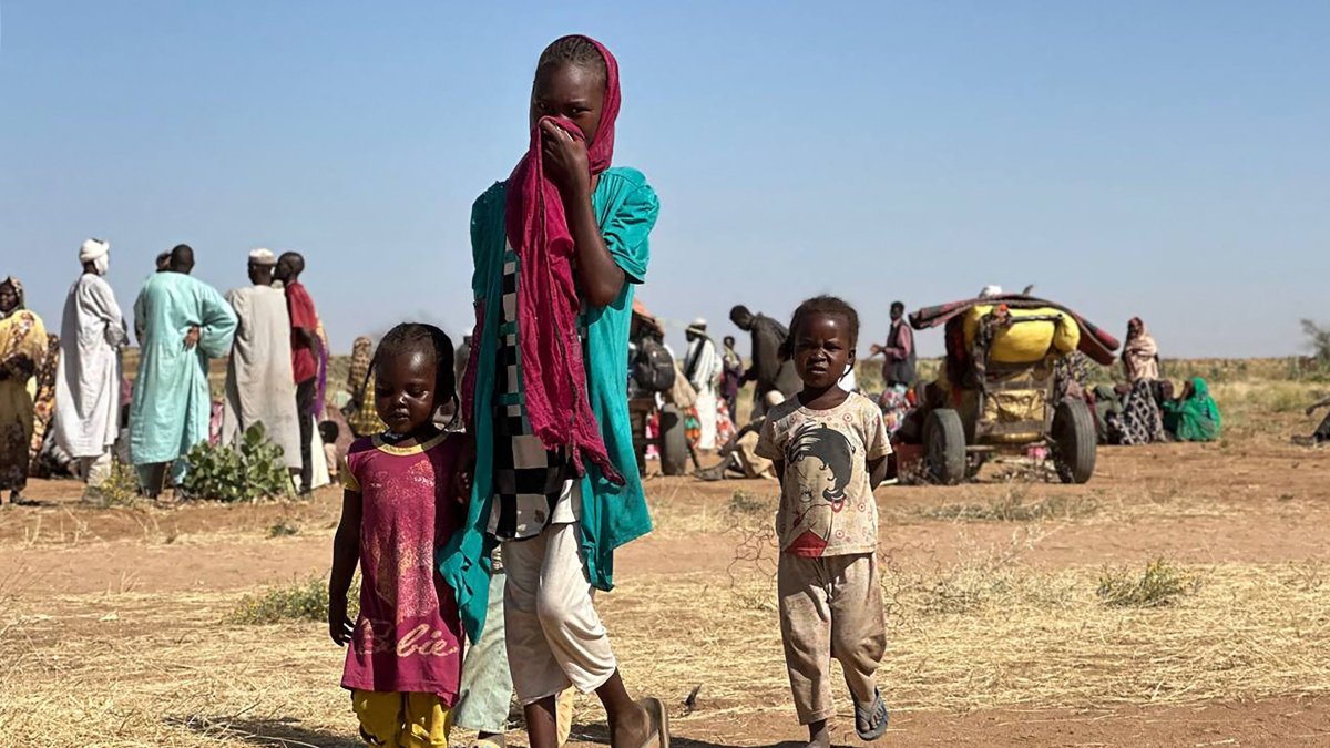 A displaced Sudanese woman, accompanied by children, walks at a camp near the town of Tawila in North Darfur, Sudan, Feb. 11, 2025. (AFP Photo)