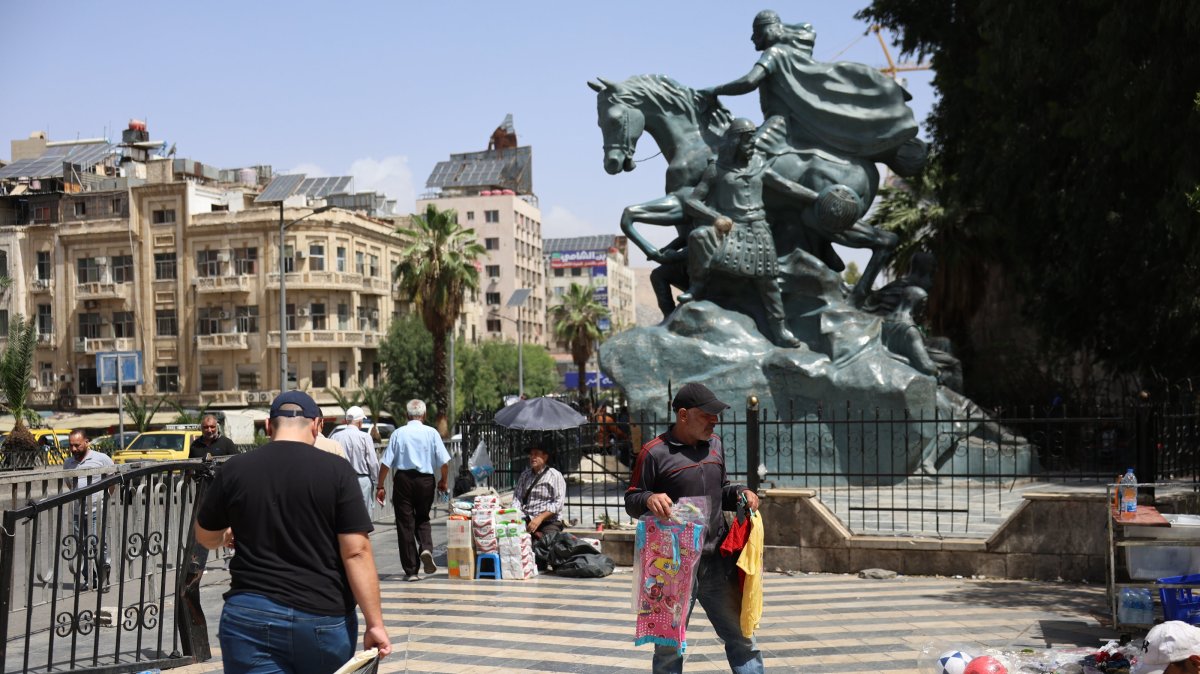People walk in central Damascus, Syria, May 14, 2025.  (EPA Photo)