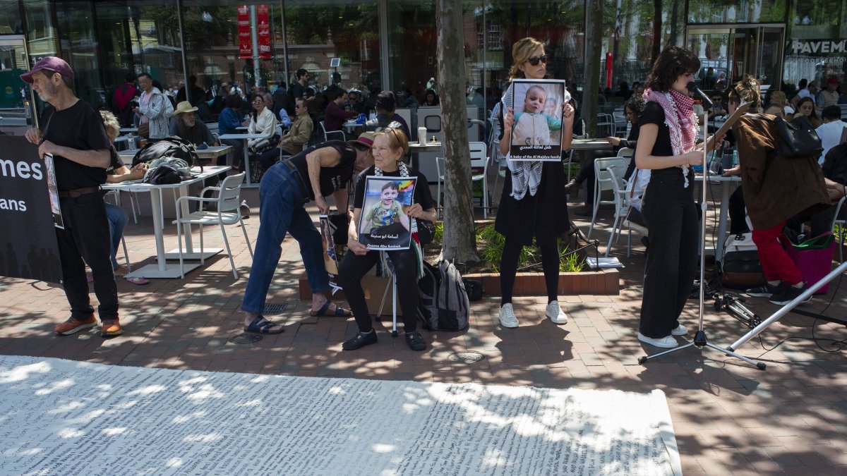 Demonstrators in Harvard Square hold photographs next to a cloth and read aloud the names of the Palestinian citizens who were killed as a result of the conflict in Gaza, outside the Harvard University campus in Cambridge, Massachusetts, U.S., May 27, 2025. (EPA Photo)