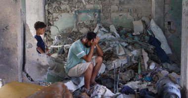 A man reacts as he sits amid the rubble at the Fahmi al-Jarjawi School in Gaza City, Palestine, May 26, 2025. (AFP Photo)