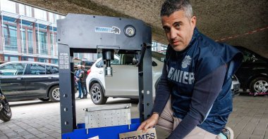 Adriano Arcangeli of the Carabinieri unit Borgo San Lorenzo stands next to a cocaine press with labels reading Godiva and Hermes, referring to the origin of the mafia clan, during a press conference to present the results of a large-scale investigation by the Belgian Federal Judicial Police of Walloon Brabant, in Nivelles, Belgium, May 27, 2025. (EPA Photo)