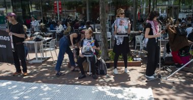 Demonstrators in Harvard Square hold photographs next to a cloth and read aloud the names of the Palestinian citizens who were killed as a result of the conflict in Gaza, outside the Harvard University campus in Cambridge, Massachusetts, U.S., May 27, 2025. (EPA Photo)