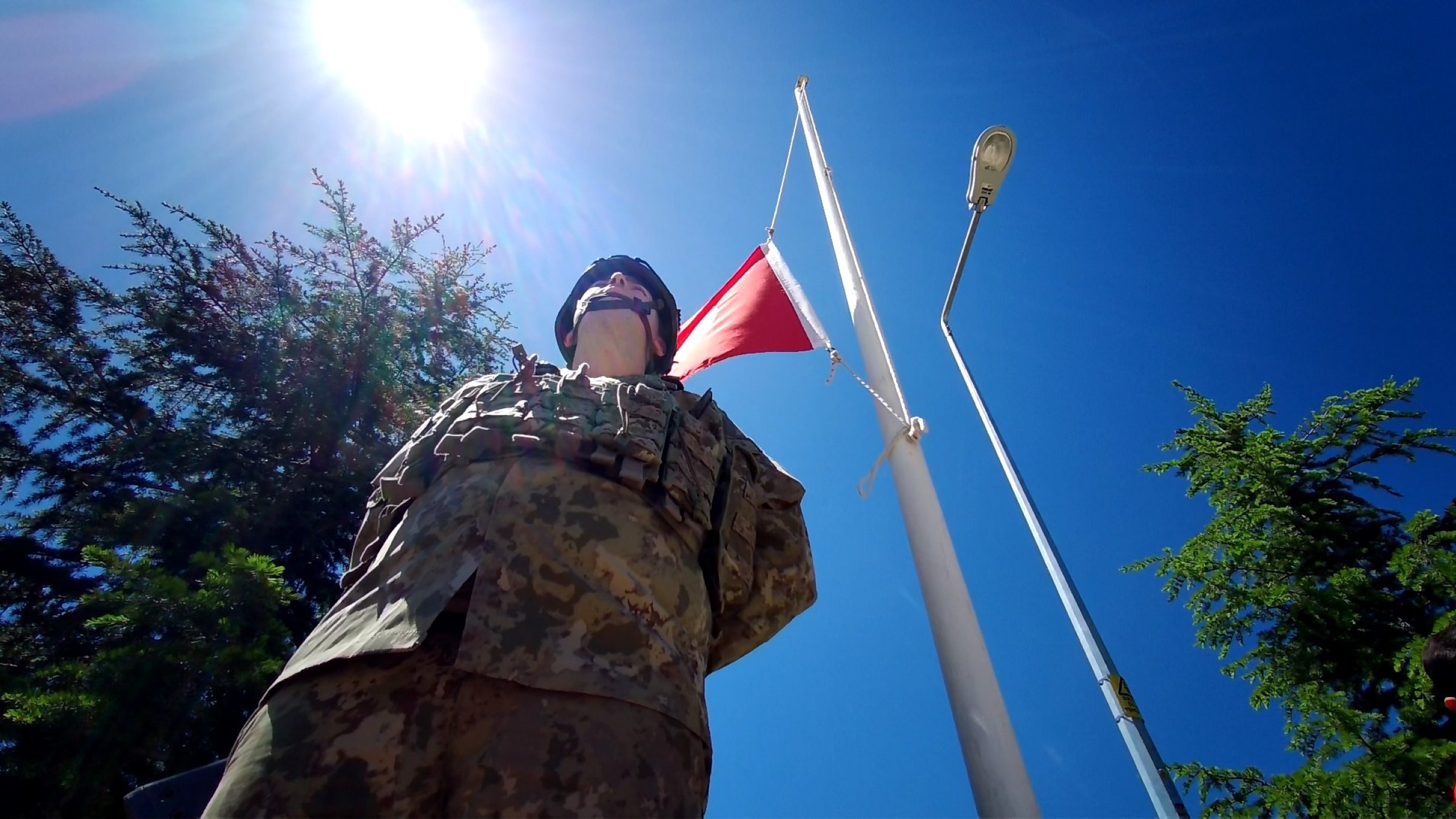 A Turkish soldier stands under a Turkish flag lowered to half-mast during a ceremony for 33 soldiers who were killed by PKK terrorists on May 24, 1993, Bingöl, eastern Türkiye, May 24, 2025. (DHA Photo)