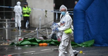 A forensics officer collects bagged evidence at the scene where a car plowed into crowds during Liverpool’s May 26 Premier League victory parade, Liverpool, U.K., May 27, 2025. (AFP Photo)