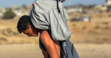A youth walks with a package on his back as displaced Palestinians receive food packages from a U.S.-backed foundation, in western Rafah, southern Gaza Strip, Palestine, May 27, 2025. (AFP Photo)