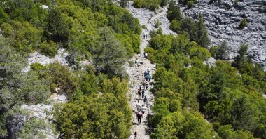 Hikers explore the restored ancient caravan and migration route winding through the natural landscape of Akseki district, Antalya, Türkiye, May 28, 2025. (AA Photo) 