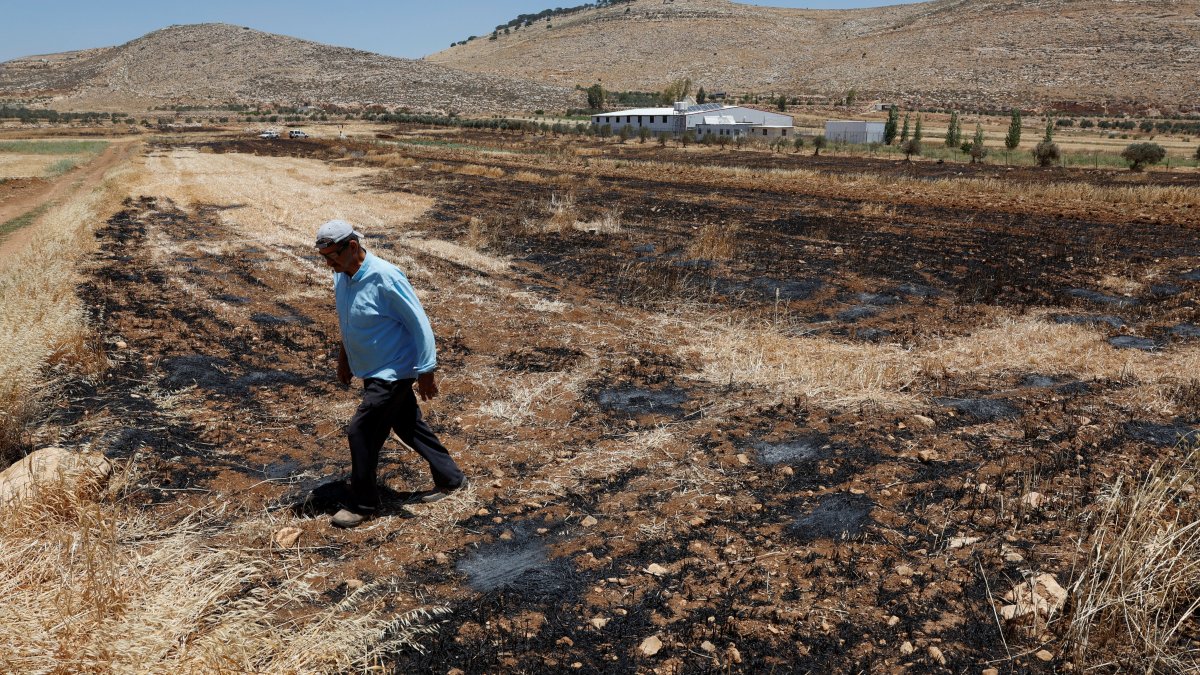 A Palestinian man walks at his farm, after an Israeli settlers attack in Al Mughayyir near Ramallah, in the Israeli-occupied West Bank, Palestine, May 28, 2025. (Reuters  Photo)