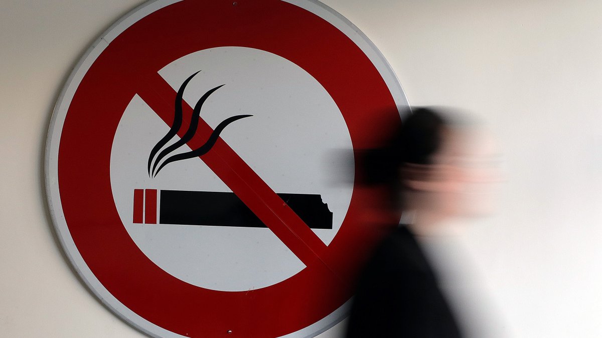 A woman walks past a no smoking sign in Nice, France, Nov. 8, 2017. (Reuters File Photo)