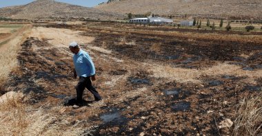 A Palestinian man walks at his farm, after an Israeli settlers attack in Al Mughayyir near Ramallah, in the Israeli-occupied West Bank, Palestine, May 28, 2025. (Reuters  Photo)