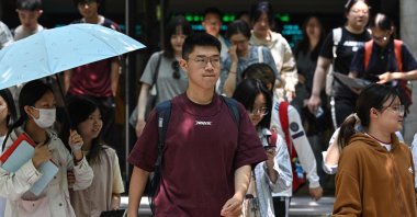 Chinese students walk at Beijing Foreign Studies University in Beijing, CHina, May 29, 2025. (AFP Photo)
