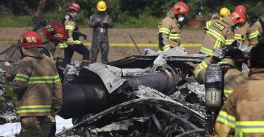 South Korean firefighters and military officers work at the scene of a South Korean navy plane crash in Pohang, South Korea, May 29, 2025. (AP Photo)