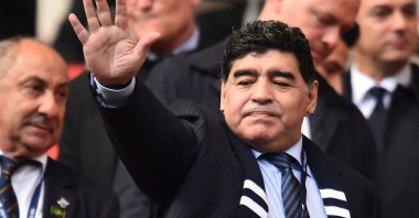 Argentinian legend Diego Maradona gestures as he takes his seat ahead of the English Premier League football match between Tottenham Hotspur and Liverpool at Wembley Stadium in London, U.K., Oct. 22, 2017. (AFP File Photo)