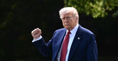 U.S. President Donald Trump raises a fist as he makes his way to board Marine One from the South Lawn of the White House in Washington, D.C., U.S., May 23, 2025. (AFP Photo)