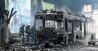 Ukrainian rescuers work to extinguish a fire in a trolleybus depot following a drone strike amid the Russian invasion of Ukraine, Kharkiv, Ukraine, May 30, 2025. (AFP Photo)